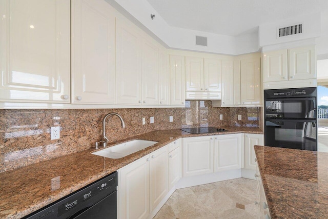 kitchen featuring dark stone countertops, sink, decorative backsplash, and black appliances