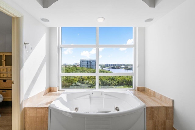 bathroom with a water view and a bathtub