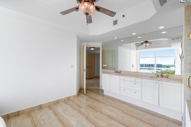 bathroom featuring vanity, ceiling fan, and a water view