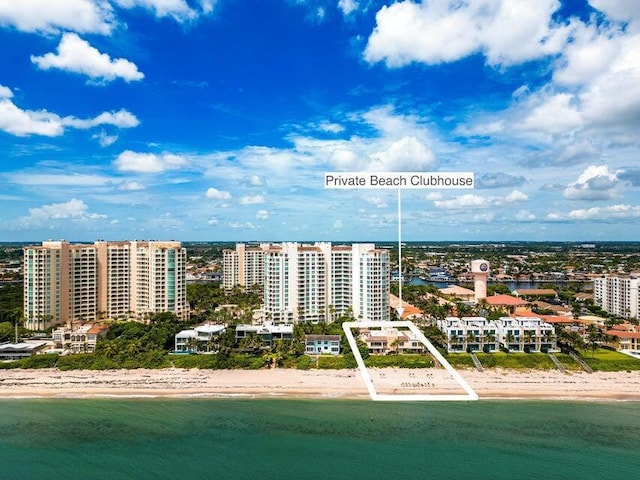 bird's eye view featuring a water view and a beach view