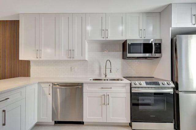 kitchen featuring white cabinetry, appliances with stainless steel finishes, sink, and decorative backsplash