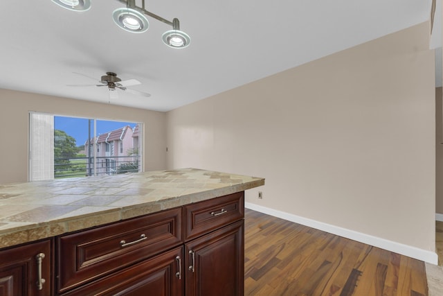 kitchen featuring dark wood-type flooring and ceiling fan