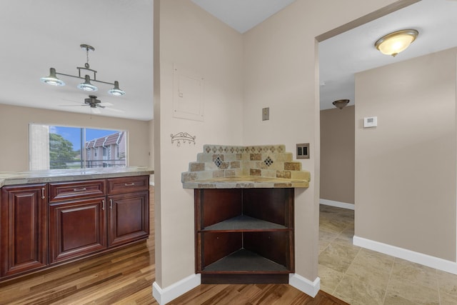 kitchen featuring ceiling fan and light hardwood / wood-style floors