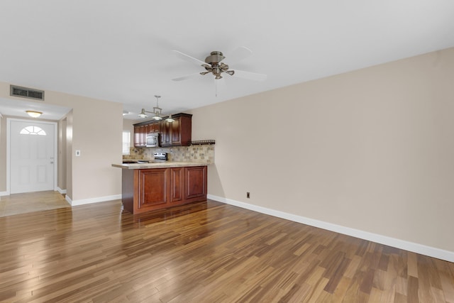 interior space with ceiling fan and hardwood / wood-style floors