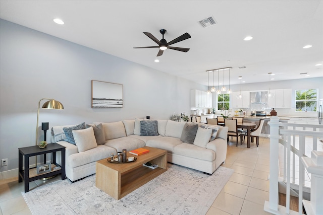 living room with ceiling fan, a healthy amount of sunlight, and light tile patterned flooring