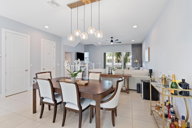 tiled dining area with ceiling fan