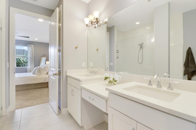 bathroom with tile patterned flooring, vanity, and walk in shower