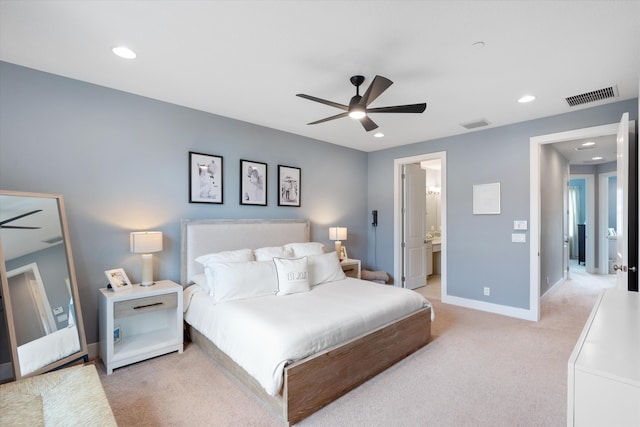 carpeted bedroom with ceiling fan and ensuite bath