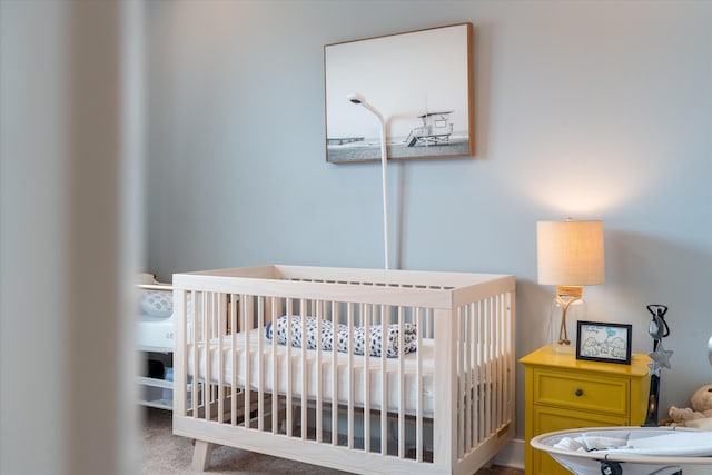 bedroom with carpet floors and a crib