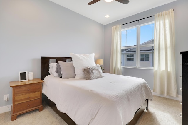 bedroom featuring light carpet and ceiling fan