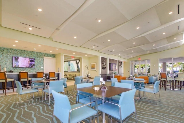 dining space with carpet flooring and vaulted ceiling