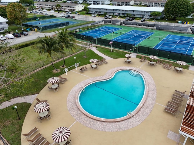 view of pool featuring a patio and tennis court