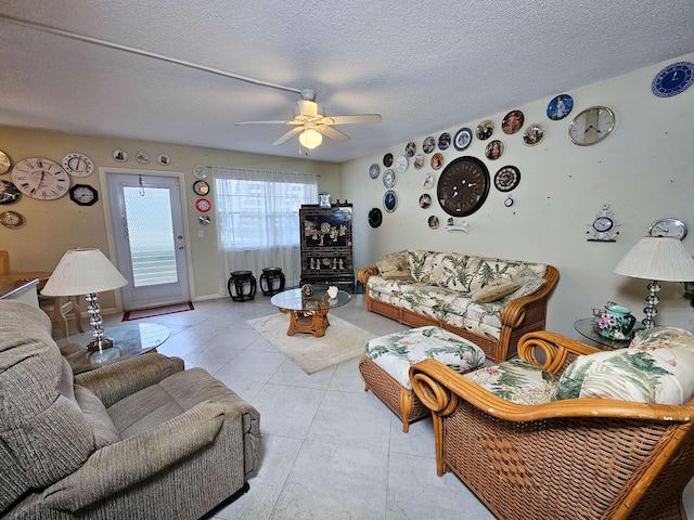 tiled living room featuring ceiling fan and a textured ceiling