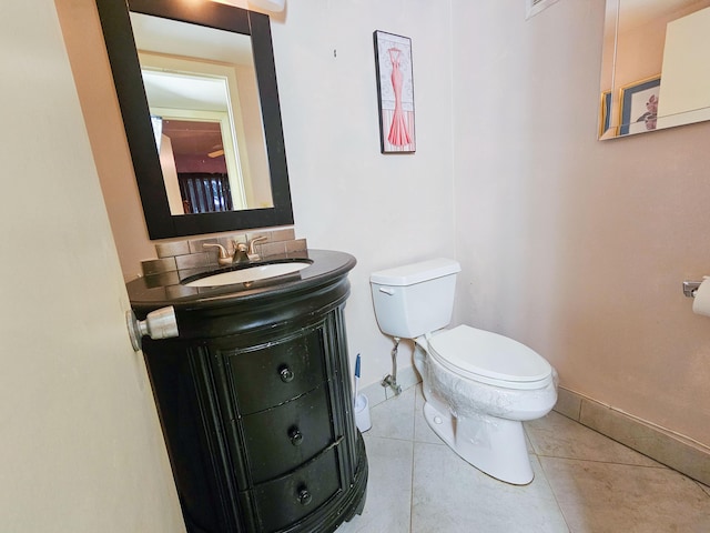 bathroom featuring vanity, tile patterned floors, and toilet