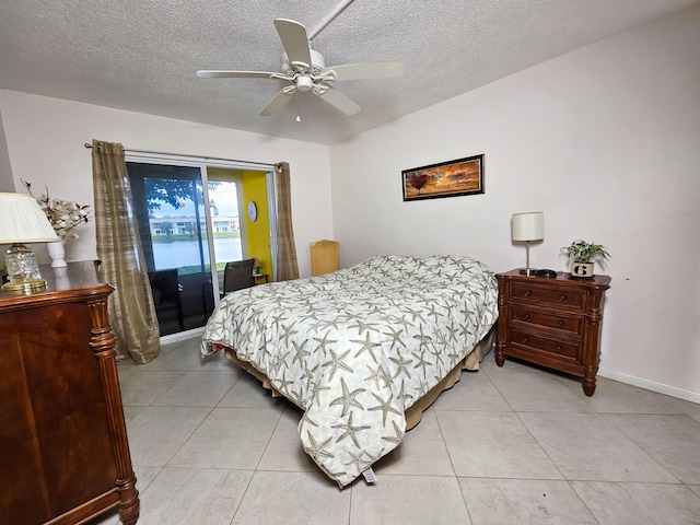 tiled bedroom featuring access to outside, a textured ceiling, and ceiling fan