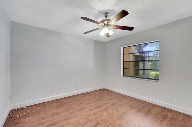 empty room with hardwood / wood-style floors, a textured ceiling, and ceiling fan