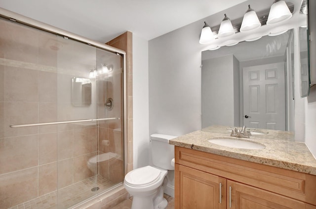 bathroom featuring walk in shower, vanity, and toilet