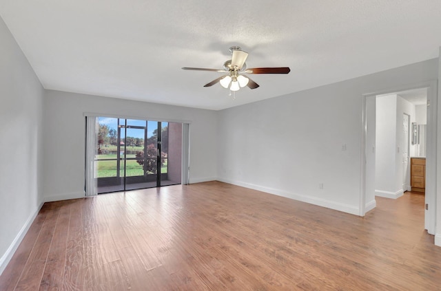 spare room featuring ceiling fan and light hardwood / wood-style flooring