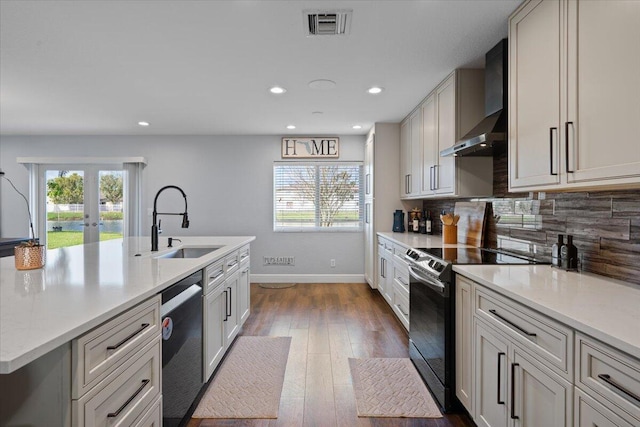 kitchen with sink, electric range oven, backsplash, stainless steel dishwasher, and wall chimney exhaust hood