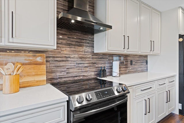 kitchen featuring electric stove, white cabinets, backsplash, and range hood