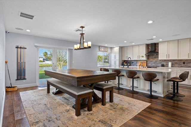 dining room with dark hardwood / wood-style flooring, sink, french doors, and a textured ceiling