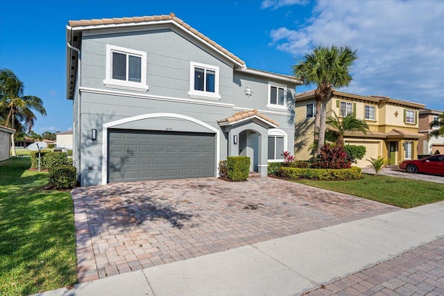 view of front of house with a garage and a front lawn