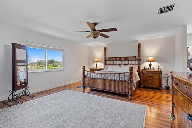 bedroom featuring hardwood / wood-style floors and a textured ceiling