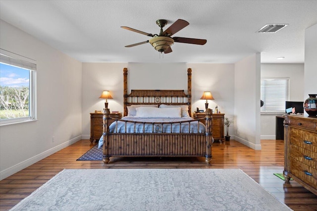 bedroom featuring hardwood / wood-style flooring and a textured ceiling