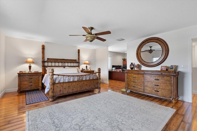 bedroom with dark hardwood / wood-style floors and a textured ceiling