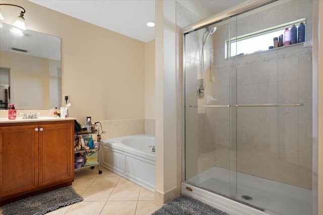 bathroom with tile patterned floors, shower with separate bathtub, and vanity