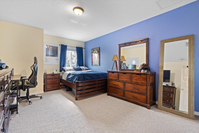 bedroom featuring light colored carpet and a textured ceiling