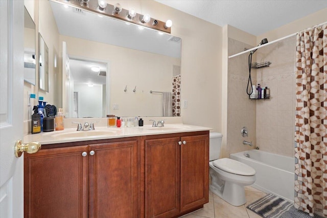 full bathroom with shower / tub combo with curtain, vanity, tile patterned floors, and toilet