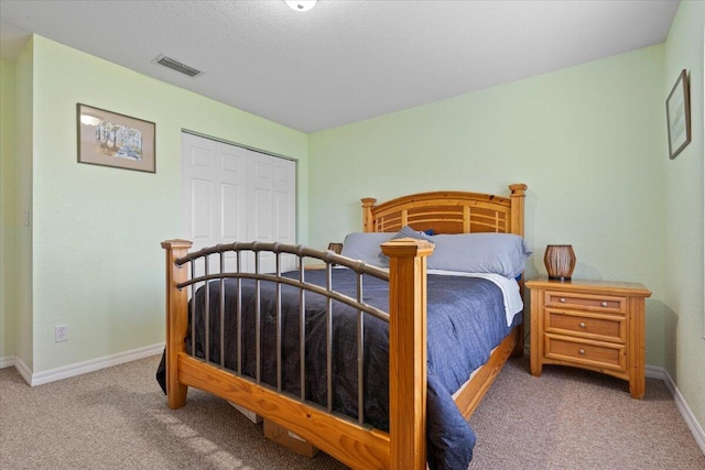 carpeted bedroom with a closet