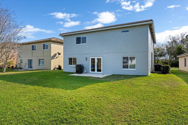 rear view of house featuring a yard and central AC