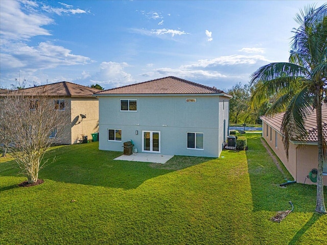 rear view of property with a yard and a patio