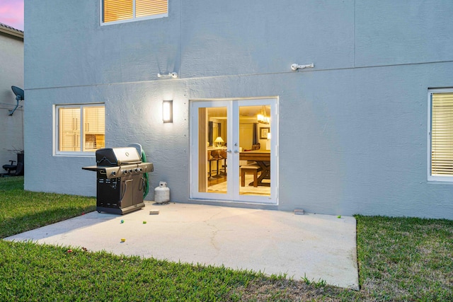 exterior space with french doors, a yard, and a patio area