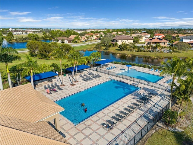 view of swimming pool with a water view and a patio