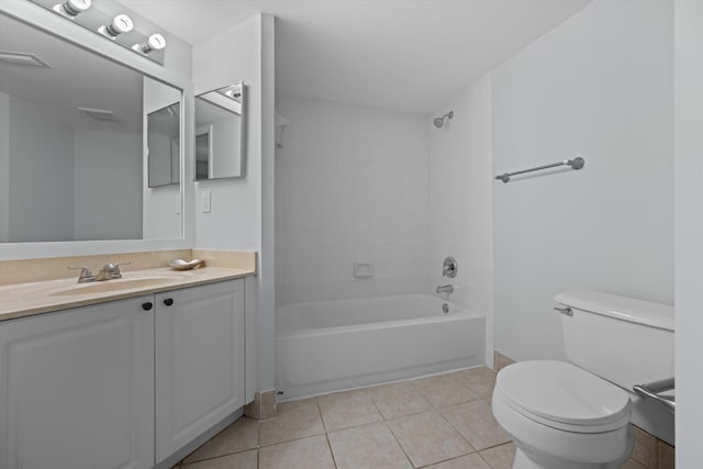 full bathroom featuring tiled shower / bath, tile patterned floors, toilet, and vanity