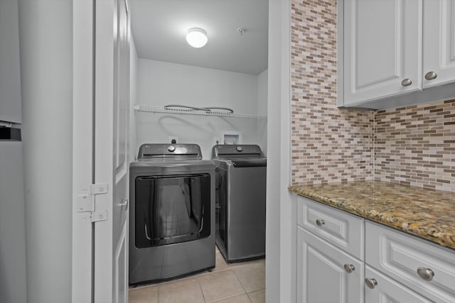 clothes washing area featuring light tile patterned floors and independent washer and dryer