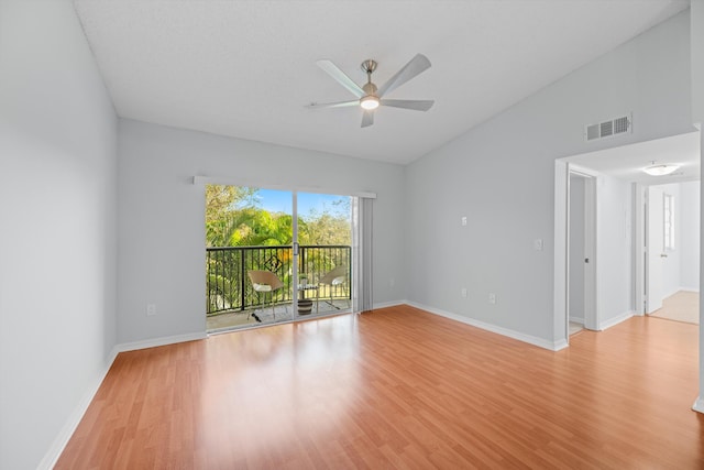 spare room with lofted ceiling, light hardwood / wood-style floors, and ceiling fan