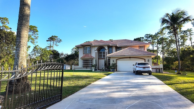 mediterranean / spanish home featuring a garage and a front lawn