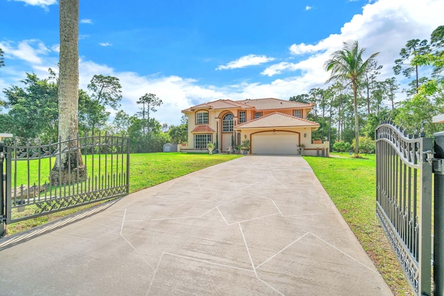 mediterranean / spanish home with a fenced front yard, an attached garage, a gate, stucco siding, and a front lawn