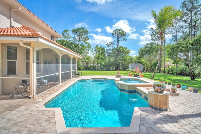 view of pool featuring a sunroom, a pool with connected hot tub, a patio area, and a lawn