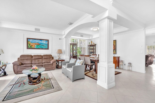 living room with ornamental molding, arched walkways, visible vents, and ornate columns