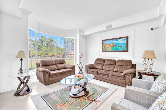 living area featuring a textured ceiling, light tile patterned flooring, visible vents, baseboards, and crown molding