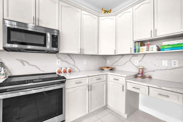 kitchen with light stone countertops, white cabinetry, appliances with stainless steel finishes, and tasteful backsplash