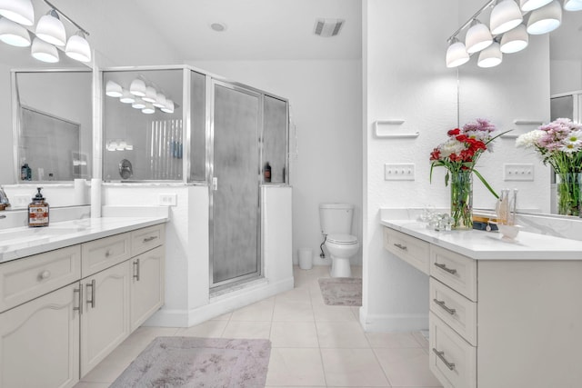 full bath with visible vents, toilet, vanity, a shower stall, and tile patterned floors