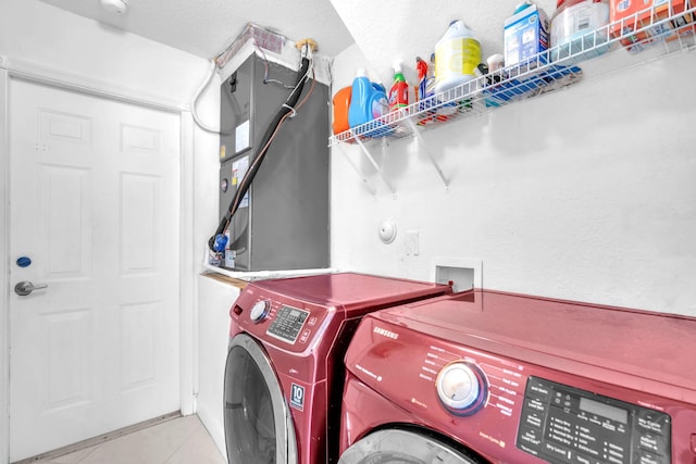 washroom featuring light tile patterned floors, laundry area, and independent washer and dryer