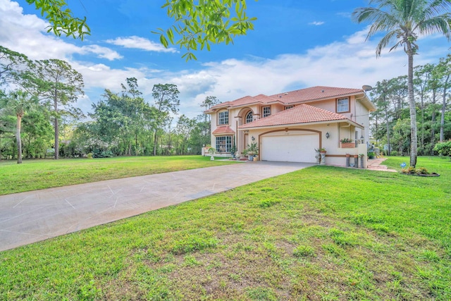 mediterranean / spanish-style house featuring an attached garage and a front lawn