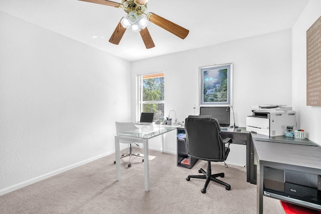 home office with baseboards, ceiling fan, and light colored carpet